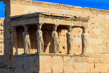 Fototapeta premium The Caryatid porch of Erechtheion (Erechtheum) or Temple of Athena Polias is an ancient Greek Ionic temple on the north side of the Acropolis in Athens, Greece