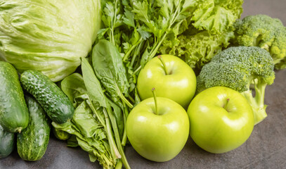 A mix of green vegetables and fruits. Front view. The concept of dietary nutrition.