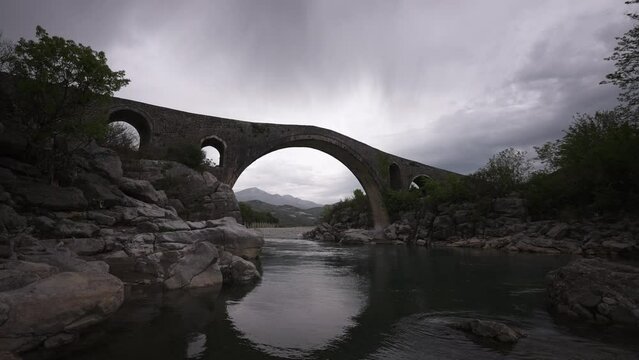 Mesi bridge in Shkod&euml;r North West Albania, wide angle view with clouds in the sky