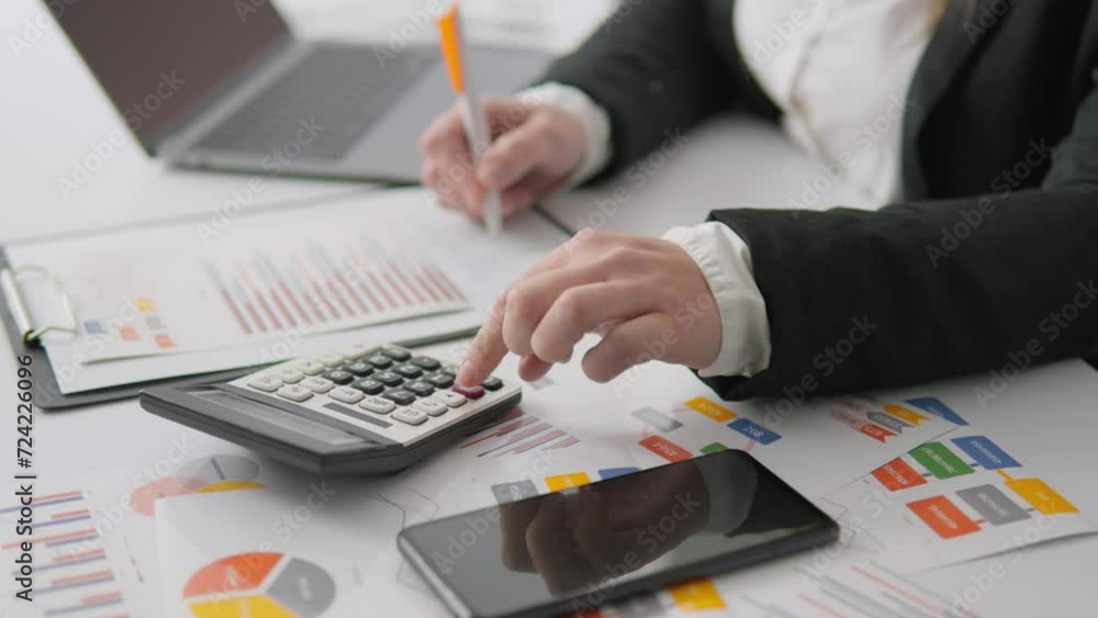 Poster The financier examines graphs and charts to analyze financial data and develop strategies to improve efficiency. The workplace of a financial analyst, where calculations, risk assessment and analysis