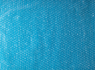 Blue background with bubble transparent foil texture. Trendy creative idea.