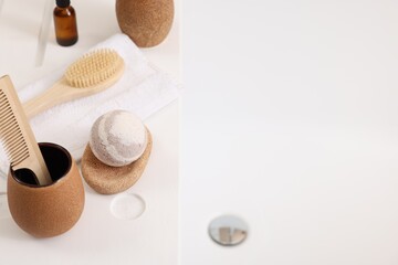 Different personal care products and accessories on bath tub, above view. Space for text