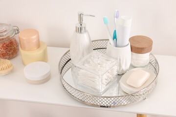 Fototapeta na wymiar Different bath accessories and personal care products on table near white wall