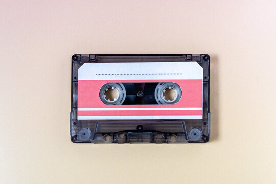 Top view of a music cassette on a yellow background.