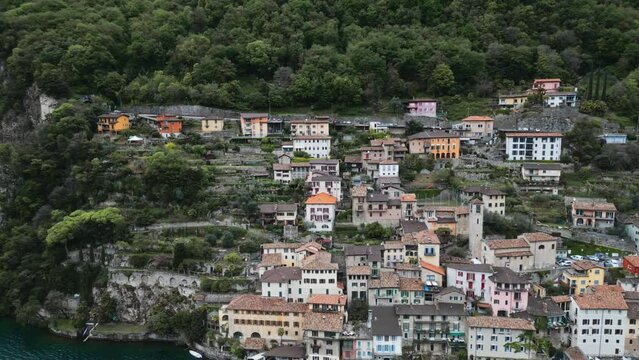 A city on the water's edge. A small Italian town. A tourist village by the river. Italy. Switzerland. Como. Gandria. Fishing village. European town. A town on a rock. Village on a cliff near the water