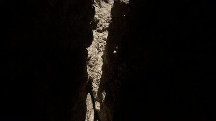 A narrow passage between two large rocks in a cave