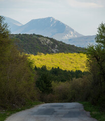 
Old winding mountain road. Mountain peaks can be seen in the background.
Country road in the Serbian mountains.