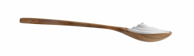One wooden spoon with sour cream isolated on white