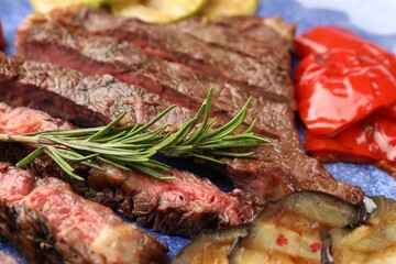 Delicious grilled beef with vegetables and rosemary on plate, closeup
