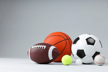 Many different sports balls on light gray background, space for text