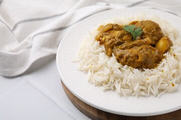 Delicious chicken curry with rice on white tiled table, closeup