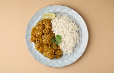 Delicious chicken curry with rice on beige background, top view