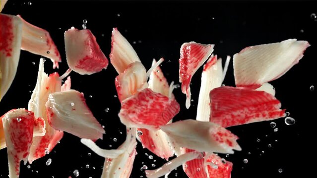 Fresh crab sticks fly up and fall down. Filmed on a high-speed camera at 1000 fps. High quality FullHD footage