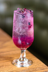 A cocktail drink with some Gin and vodka Lemon Blueberry Honey Soda