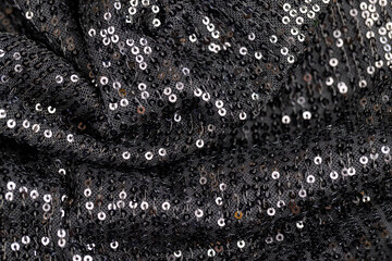 a large number of sequins on a black material