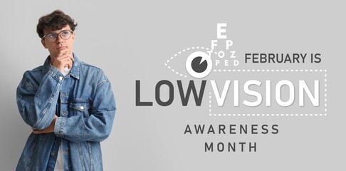 Thoughtful young man in eyeglasses on grey background. February is Low Vision Awareness Month
