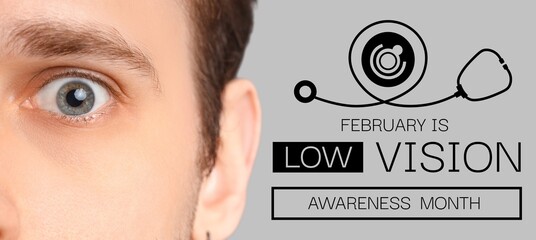 Young man on grey background, closeup. February is Low Vision Awareness Month