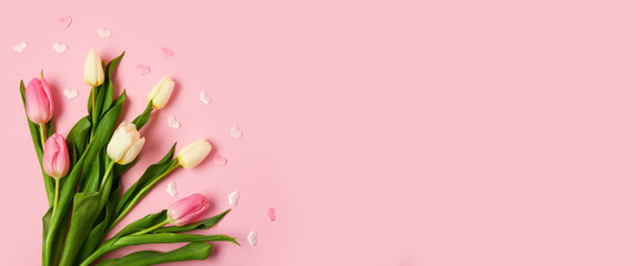 Beautiful tulips and hearts on pink background with space for text. International Women's Day