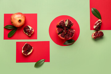 Fresh pomegranates and leaves on colorful background