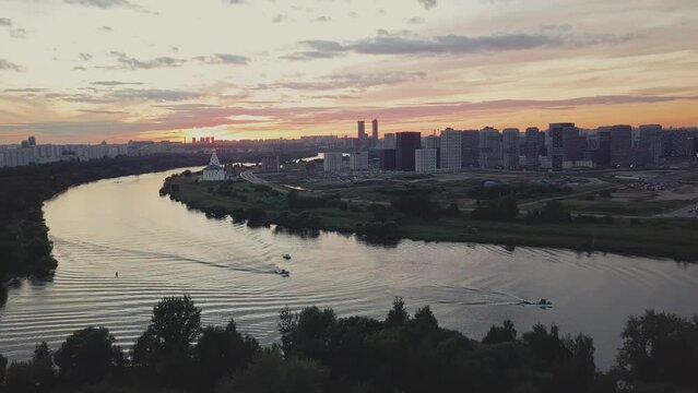 A green district of city with parks, river and high-rise residential buildings.