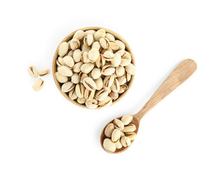 Wooden spoon and bowl with tasty pistachio nuts on white background