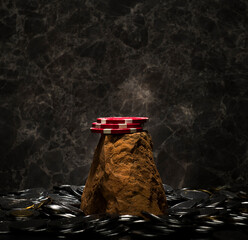 poker chips on a stone on a dark background