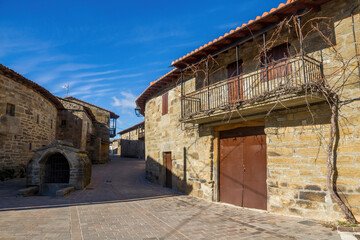 Street of the town of Villardeciervos with old stone buildings, balconies and fountain. Zamora. Spain 