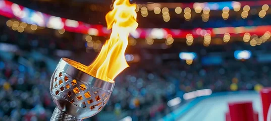 Poster Olympic torch flame burning against blurred sports arena with copy space for text placement © Ilja