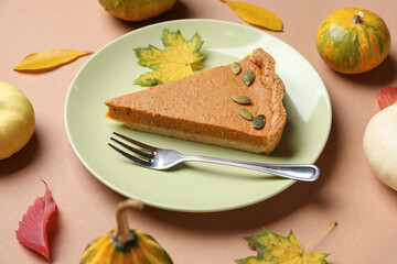 Autumn composition with tasty pumpkin pie on brown background
