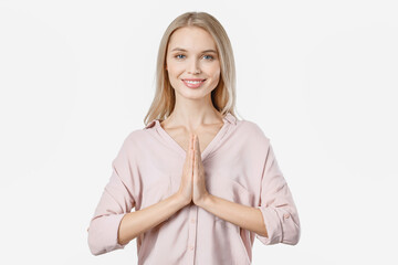 Caucasian female holding hands in namaste or prayer, practicing yoga and meditating. Contemplation...