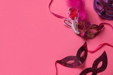 Carnival masks on pink background