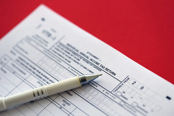 Indonesian tax form 1770-1 Individual Income Tax Return and pen on table close up