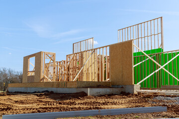 frame of a new house against a blue sky