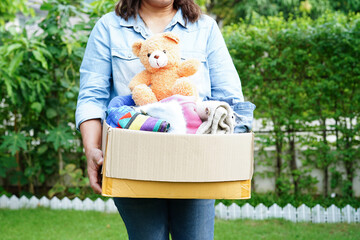 Clothes donations in cardboard box for volunteer.