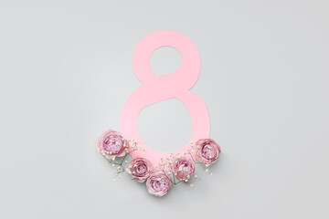 Figure 8 made of paper with beautiful roses and gypsophila flowers on grey background. International Women's Day
