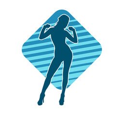 Silhouette of a slim female in dance pose. Silhouette of a woman dancing.