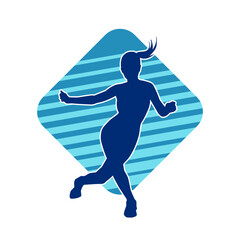 Silhouette of a female dancer in action pose. Silhouette of a slim woman in dancing pose.