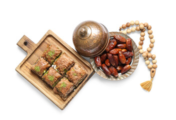 Composition with traditional Eastern sweets and tasbih for Ramadan on white background