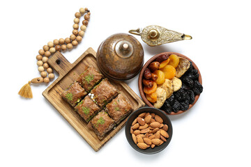 Composition with traditional Eastern sweets, Aladdin lamp and tasbih for Ramadan on white background