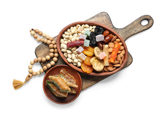 Wooden board with traditional Eastern sweets and tasbih for Ramadan on white background