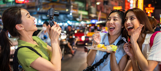 Asian young women vlogger use camera record vlog while travel in city. 