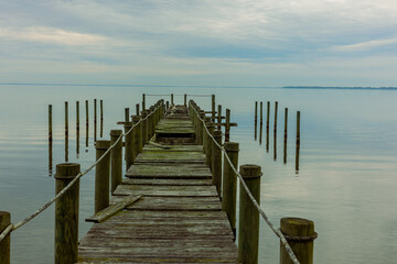 Naklejka premium Storm Damaged Dock On Body of Water
