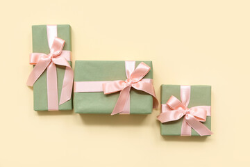 Green gift boxes on yellow background. International Women's Day