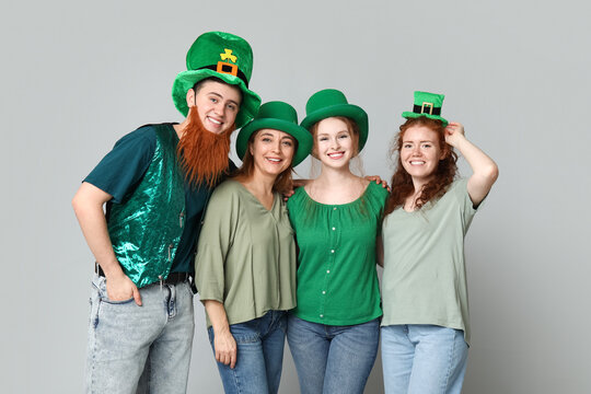 Group of people in hats on light background. St. Patrick's Day celebration