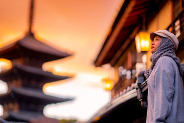 Travel, muslim travel, Asian Muslim female tourist walking at Yasaka Pagoda and Sannen Zaka Street in Kyoto Japan, Yasaka Pagoda is the famous landmark and travel, in the evening sunset.