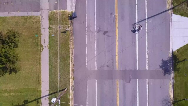 drone follows bicycle in suburbs