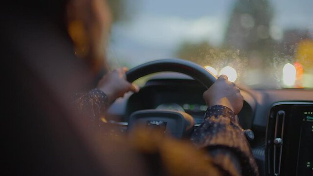 Young African Woman Driving Car On Urban City Street Commuting