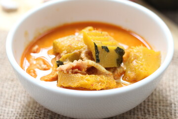 Red Curry Pumpkin with pork served on wooden table, delicious Thai food popular in Thailand, Asia food.