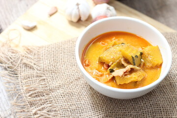 Red Curry Pumpkin with pork served on wooden table, delicious Thai food popular in Thailand, Asia food.