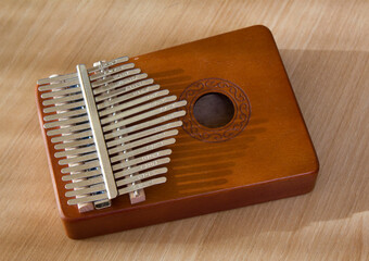 This is a kalimba placed on a wooden table.